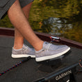 Load image into Gallery viewer, A guy on a boat with his foot on a trolling motor with Camp Shoes on. The shoes are grey.