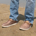 Load image into Gallery viewer, A guy standing in the sand on the beach with a pair of Camp Shoes on.