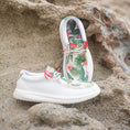 Load image into Gallery viewer, A pair of Camp Shoes sitting on the beach. The shoes are a tropical pattern.