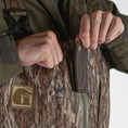 Load image into Gallery viewer, men's omega zip wader mossy oak bottomland snap view