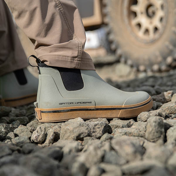 man standing on rock wearing gravel camp boots