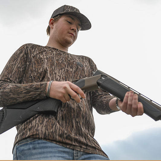man wearing performance shirt in mossy oak bottomland