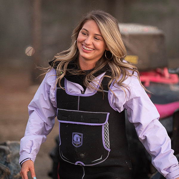 Happy woman walking and wearing purple and black Gator Waders Retro Waders.  
