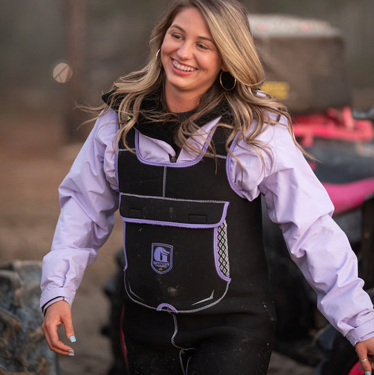 A girl walking in a pair of women's purple retro waders from Gator Waders. 