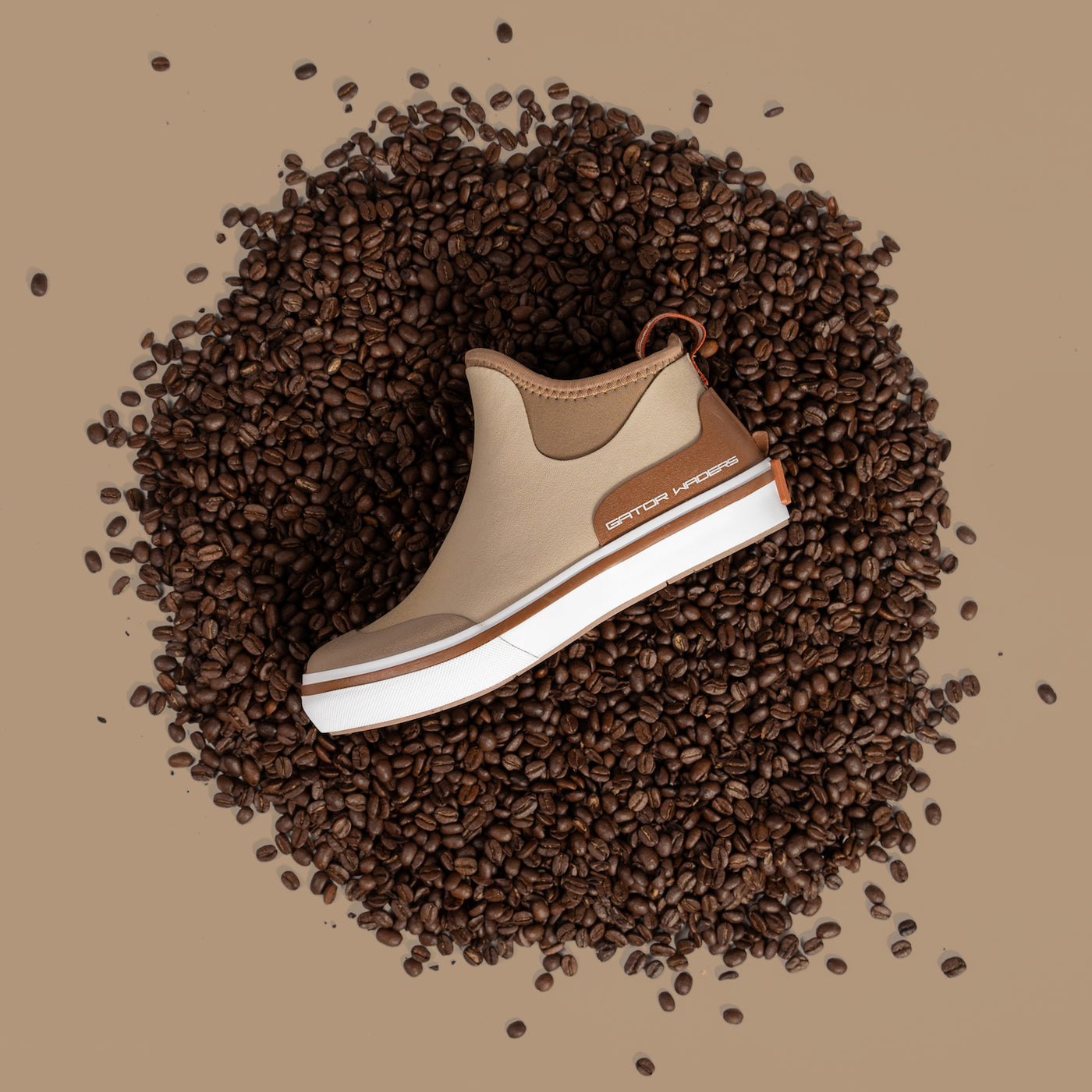 A picture of a camp boot from Gator Waders laying on a pile of coffee beans. 