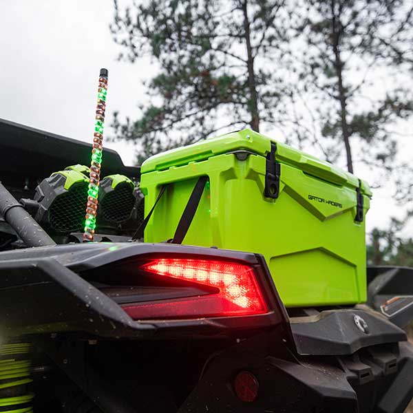 Close up of a Gator Waders 45 quart lime green hard cooler on the back of a 4 wheeler